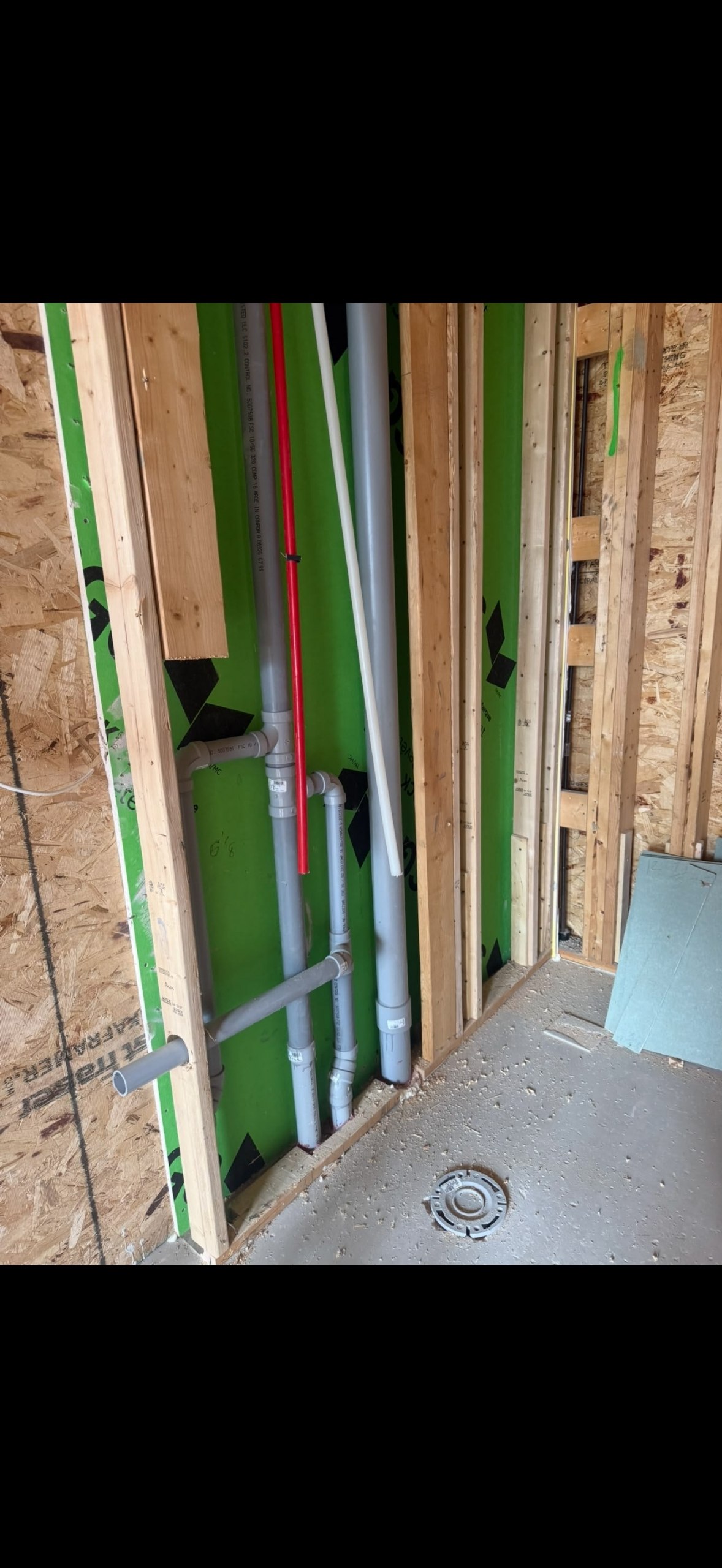 Plumbing pipes installed inside a framed wall
