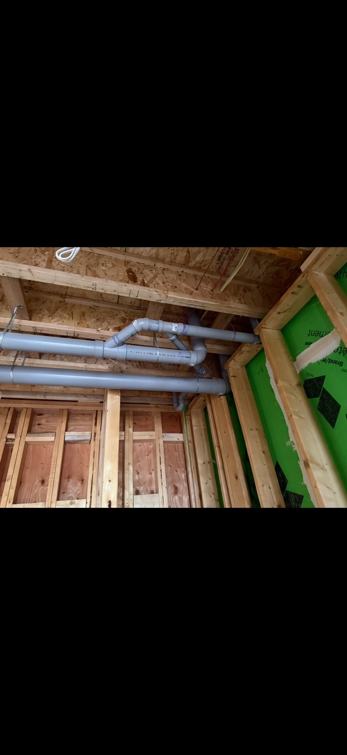 Large drain lines installed between ceiling joists